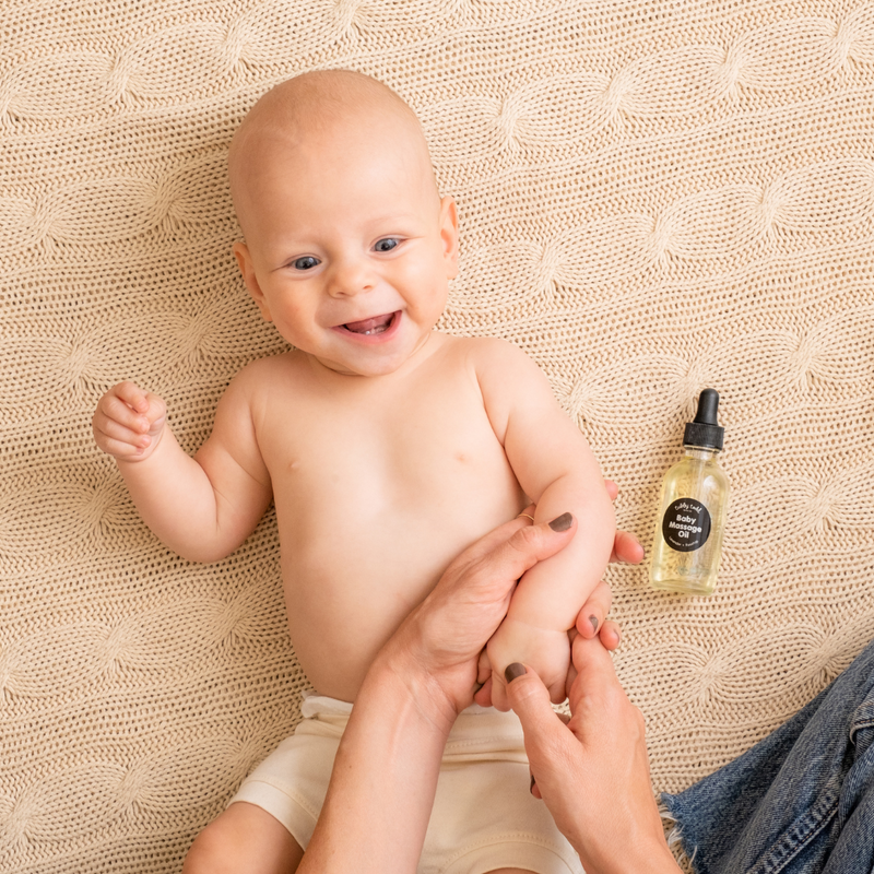 Mama applying Baby Massage Oil to little one's skin