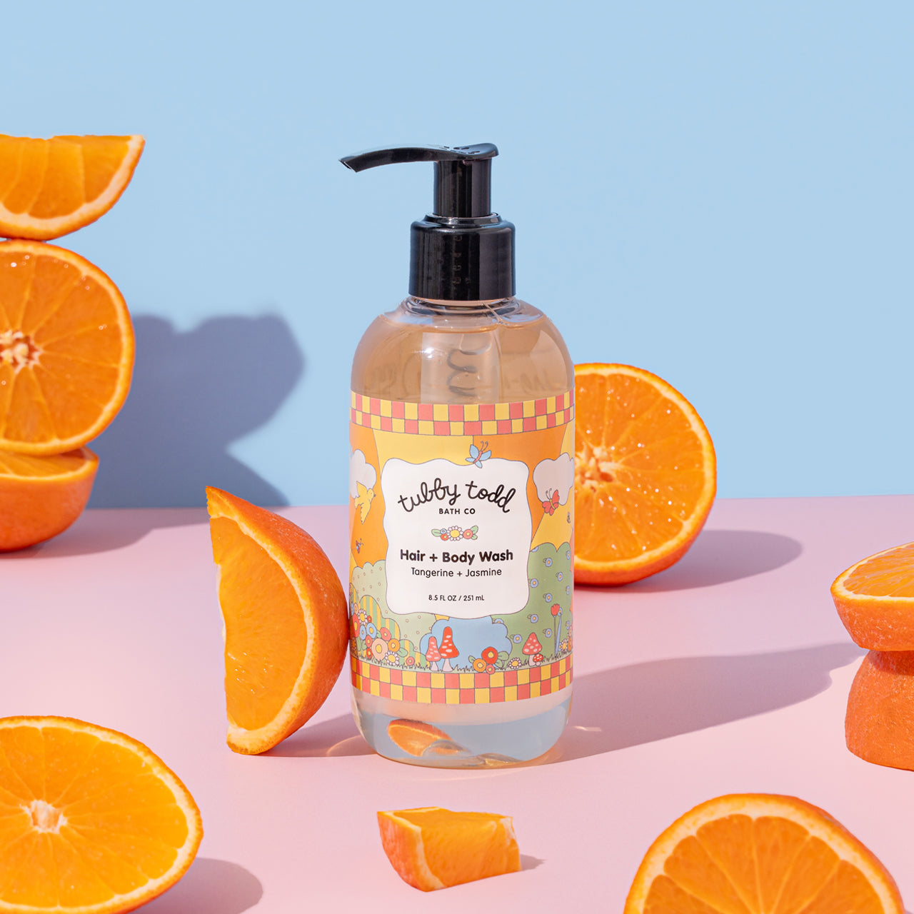 tangerine + jasmine hair + body wash surrounded by orange slices