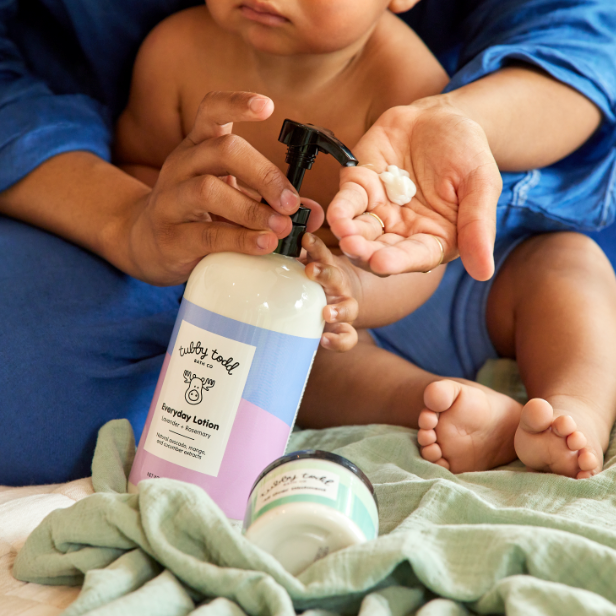 Mother pumping Everyday Lotion onto hands