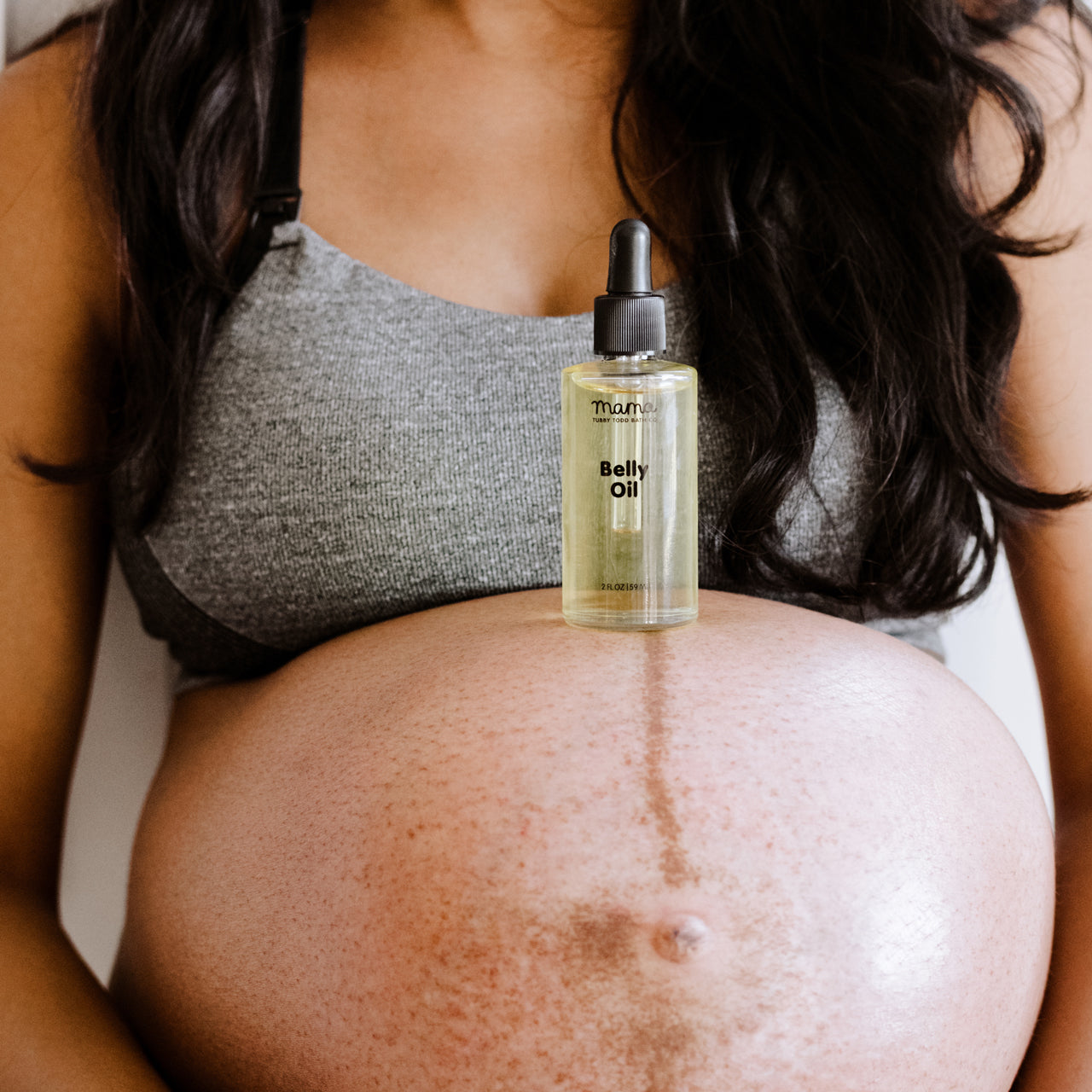 Belly Oil resting on Mama's baby bump