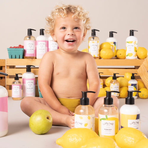 lemon creme products next to smiling toddler