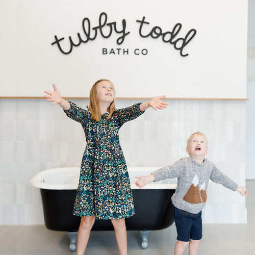 Children standing in front of Tub Hub bathtub