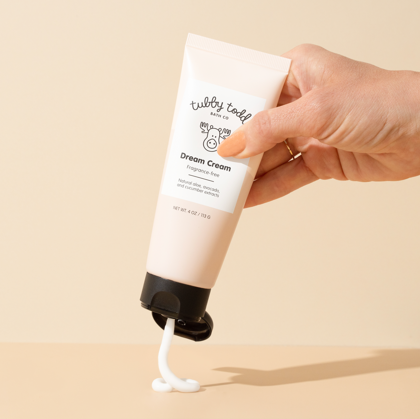 hand squeezing out Fragrance-free Dream Cream