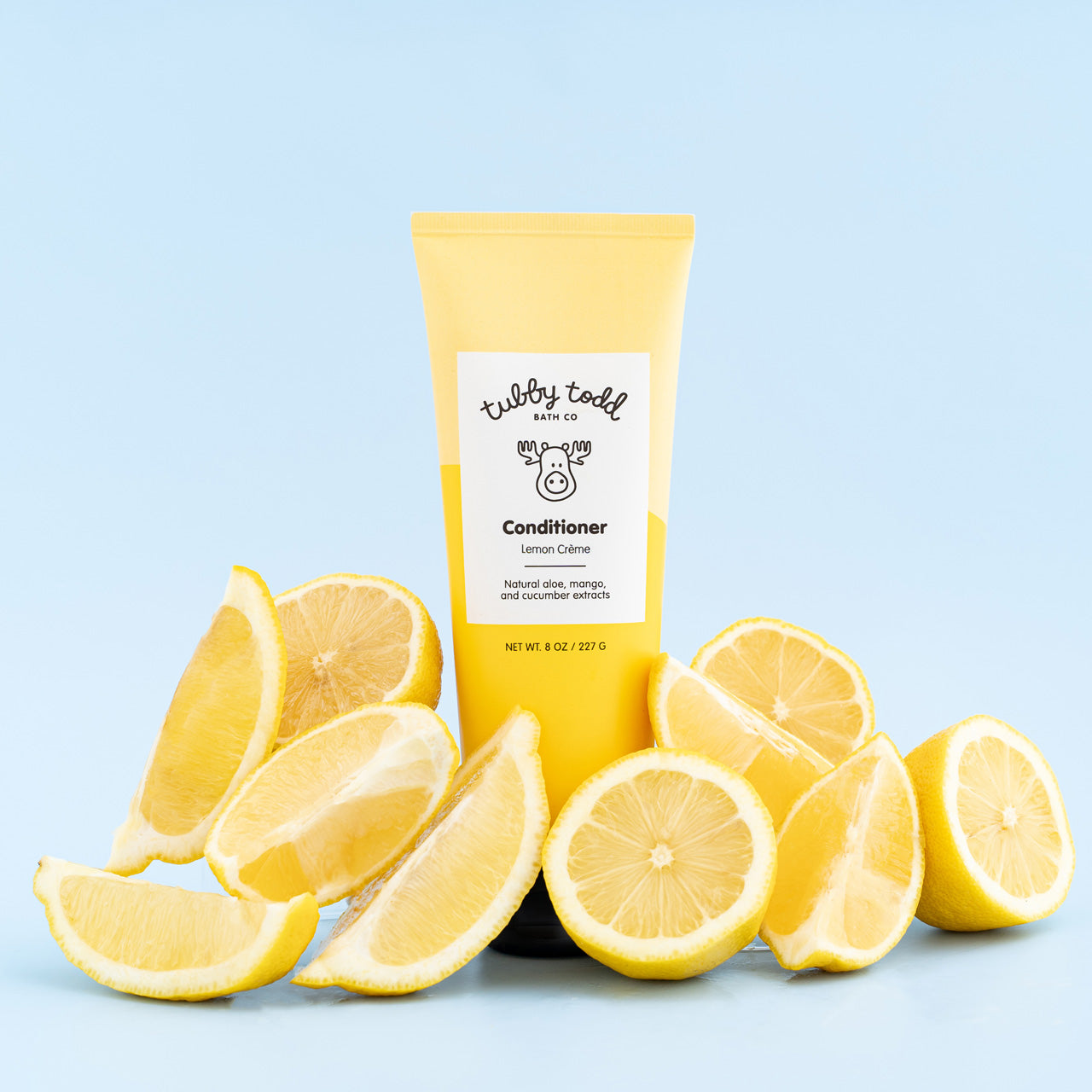 Lemon Crème Conditioner tube standing with lemons
