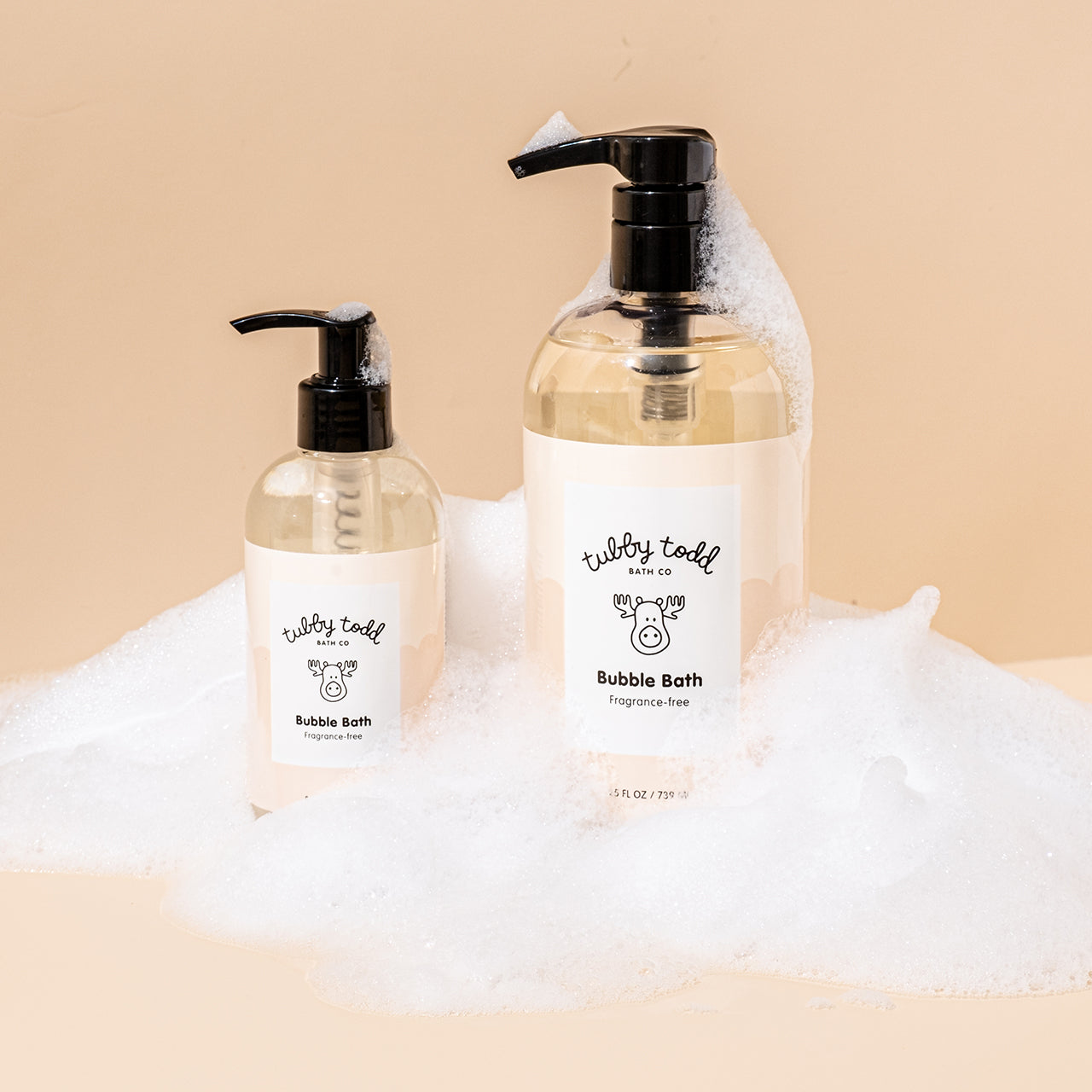 8.5oz and 25oz Fragrance-free bubble bath bottles are standing surrounded by bubbles.