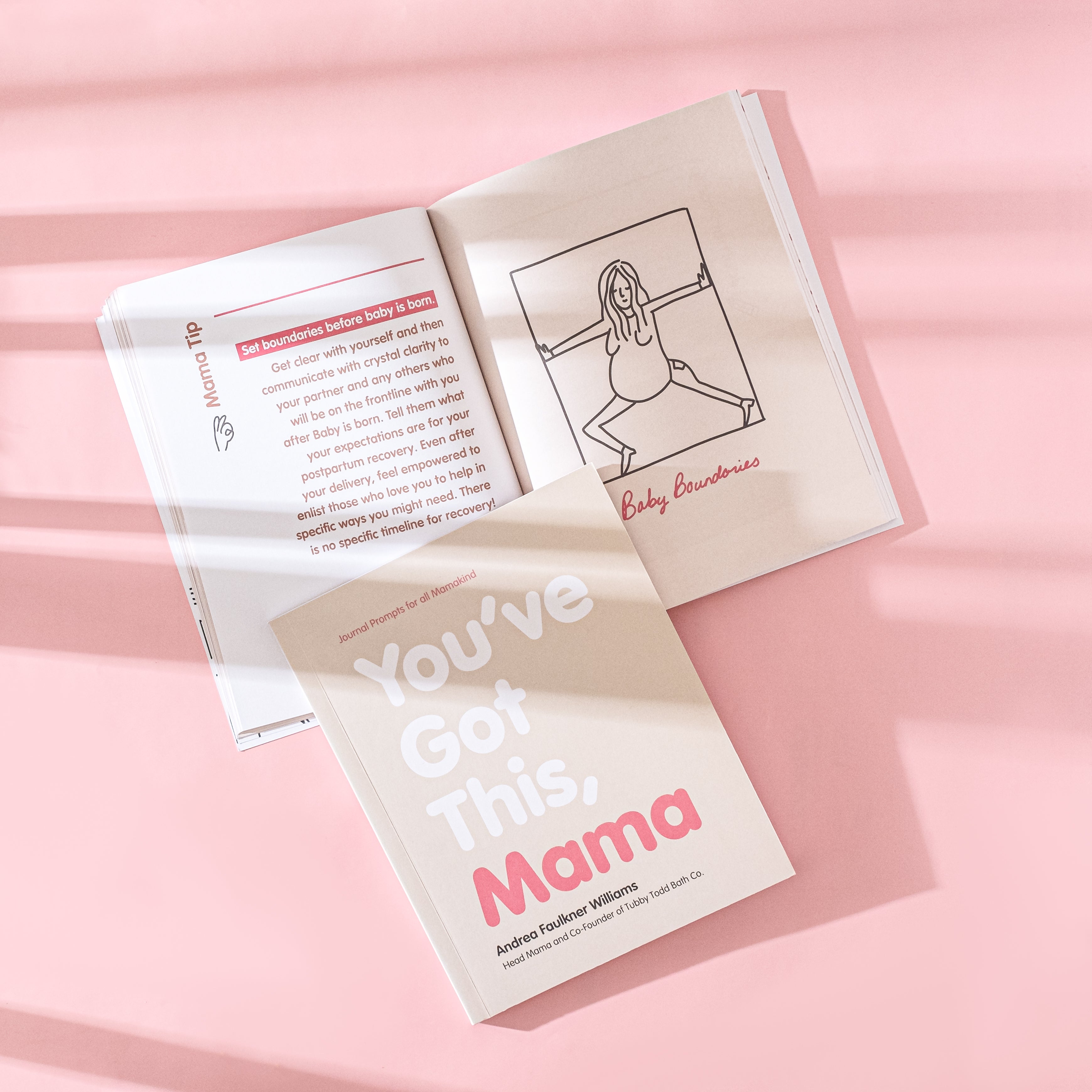 One open Mama Book and the other are placed on top of it.