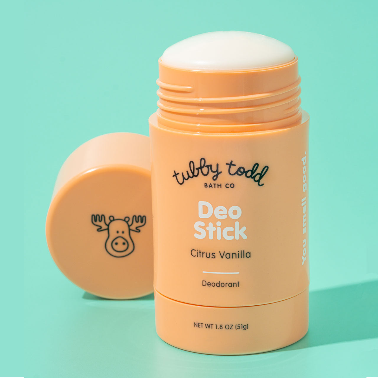 Citrus Vanilla Deo Stick with cap open standing on mint background