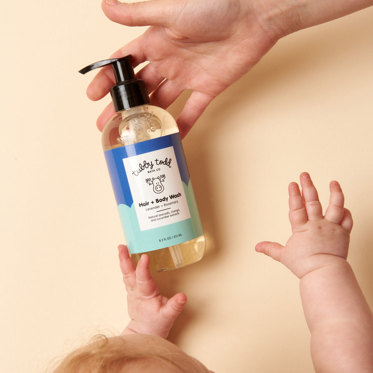 Baby reaching for Lavender Rosemary HBW 8.5oz bottle